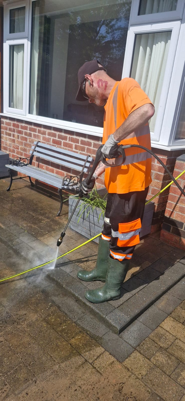 In progress: pressure-washing a block-paved patio