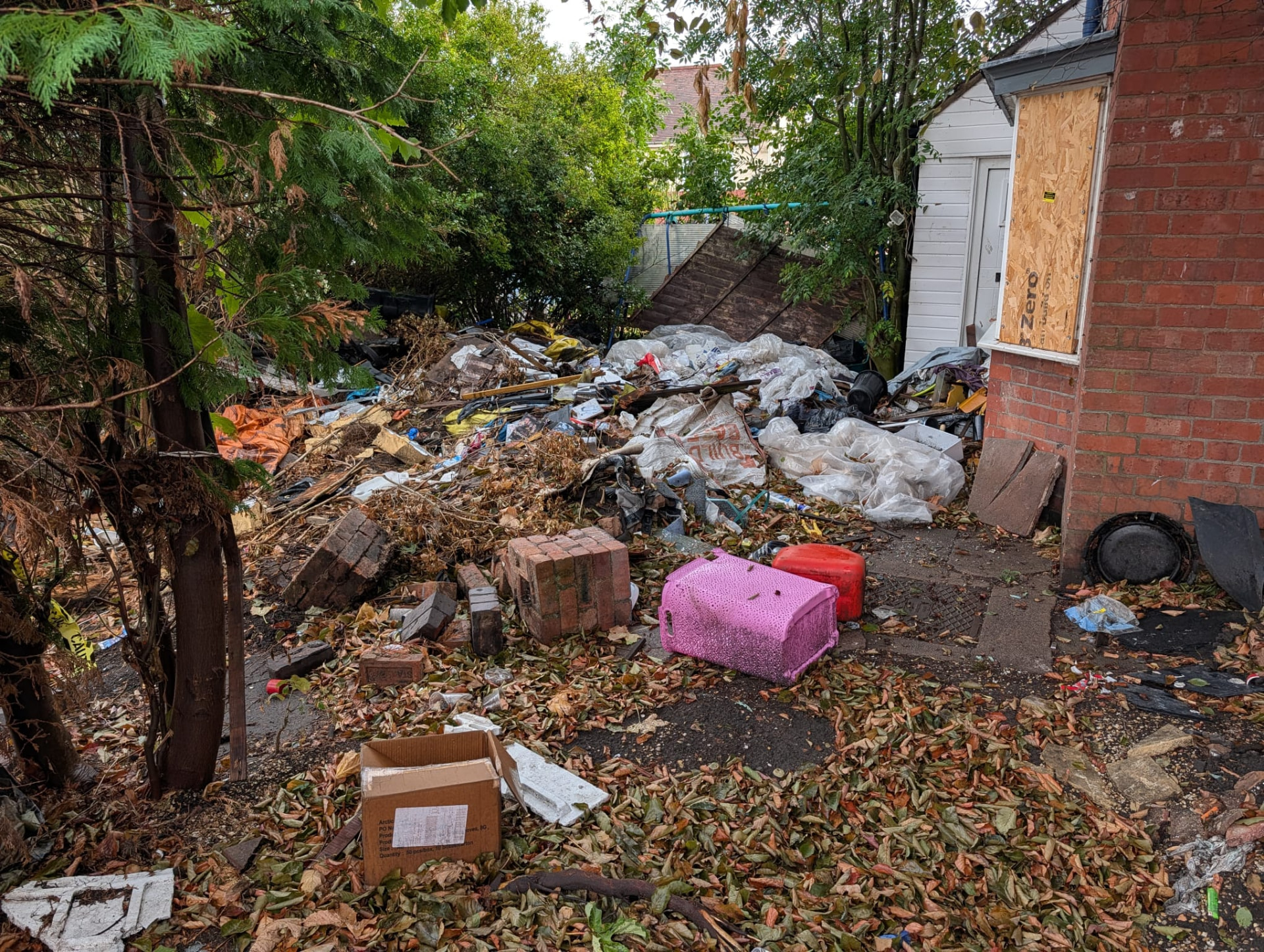 Before: yard piled with household waste and rubble