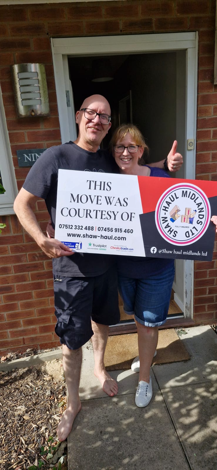 Thumbs up from customers holding the Shaw Haul move sign
