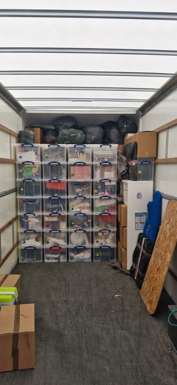 Luton neatly stacked with clear storage boxes