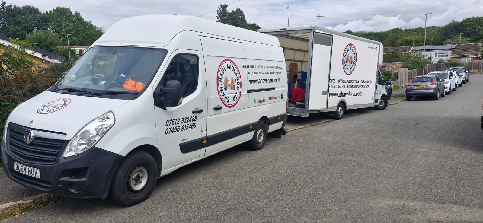 Shaw Haul panel van and open Luton parked on a residential street