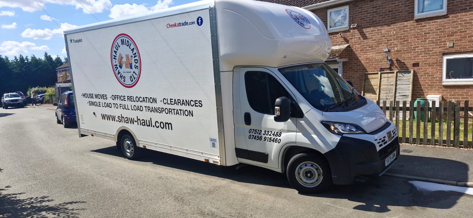 Side view of the Shaw Haul Luton on a sunny residential street