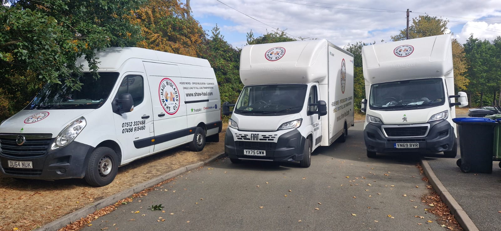 The Shaw Haul removals fleet lined up — panel van and two Luton vans