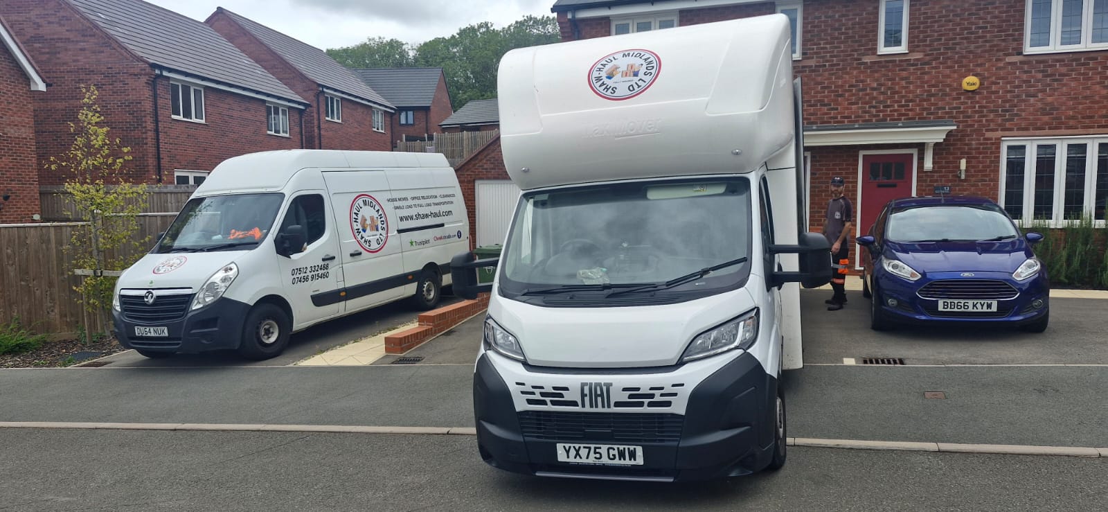 Shaw Haul Luton and panel van on a new-build driveway with a crew member