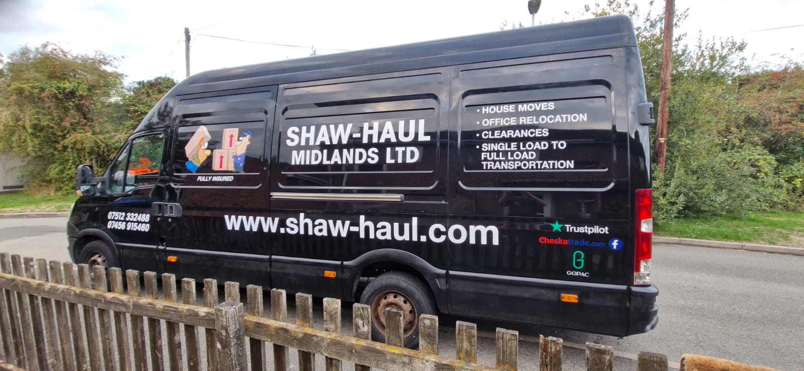 Side view of the black Shaw Haul Midlands van