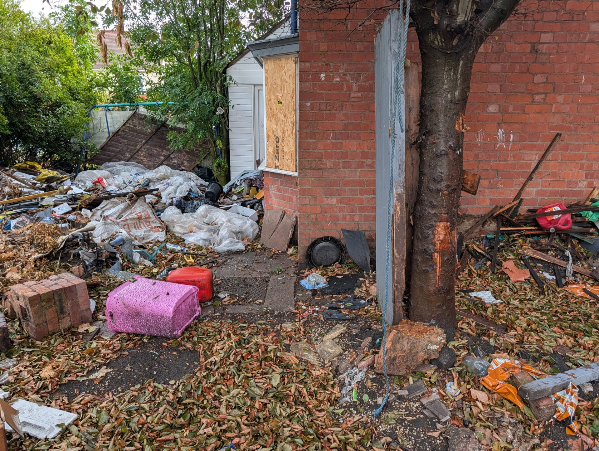 Before: garden and path covered in rubbish